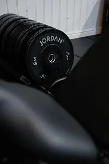 Barbell Prints: A black weight plate with the word Jordan on it