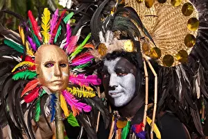 Filipino Prints: A black and white face painted street dancer holding a gold mask