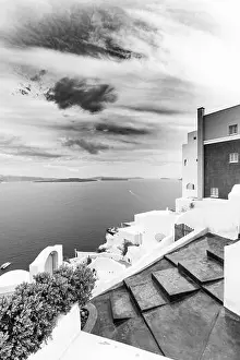 Black and white image of white architecture in Santorini Oia, Greece. Monochrome travel landscape. Dramatic process, Aegean sea in black and white