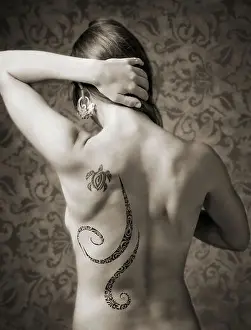 Trouble Prints: Black & white studio portrait of tattoos on a beautiful young nude woman