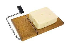 Dairy Product Prints: A block of aged Swiss cheese on an old wood cheese cutting board with wire and handle on a white background