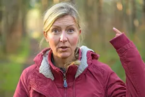 Ponytail Prints: Blond woman in red jacket showing up her long sleeve hiding the hand almost entirely