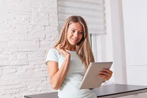 Unbelievable Prints: Blonde girl using tablet, surprised expression on her face