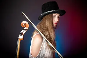 Lace Prints: A blonde woman stands back to back with her cello