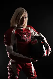 20 30 Prints: Blonde woman wearing a motorbike suit holding a helmet under her arm