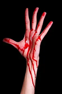 Slimy Prints: bloody human hand isolated on black background