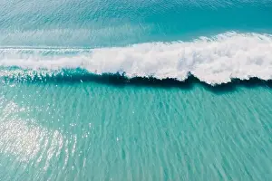 Surfer Prints: Blue clear ocean and surfing wave. Surfing waves in tropics. Aerial view