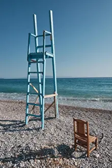 Palette Prints: Blue lifeguard seat tower and chair on a beach in Albania with the island of corfu in the distance