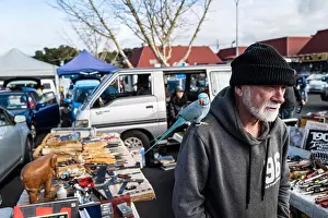 Hoodie Prints: A blue Parrot sits on the shoulder of it's owner while he browses the market tool stall at Browns Bay Sunday market