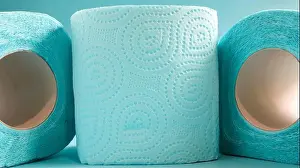 Softness Prints: Blue roll of modern toilet paper on a blue background