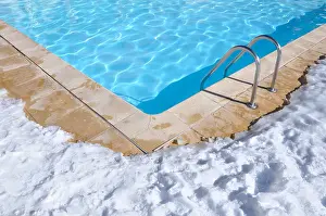 Watershed Prints: blue water of a swimming pool with outdoor terrace covered in snow