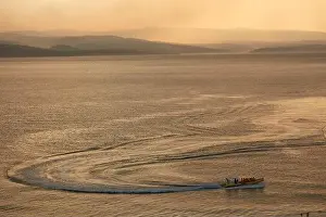 Cruising Prints: A boat with passengers on calm