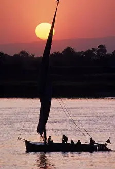 Nile Prints: Boat sails on the Nile River at sunset near Luxor, Egypt