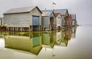 Rowan Prints: Boathouse and their reflection in a small harbor in Port Rowan, Ontario, Canada
