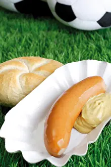 Turf Prints: Bockwurst sausage with mustard and bread roll on a football turf