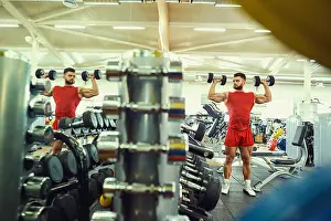 Barbell Prints: Bodybuilder with dumbbells doing exercises in the gym