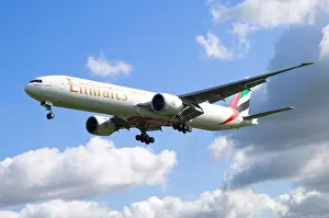 Boeing 777 Prints: Boeing 777 operated by Emirates on approach for landing at Birmingham Airport, UK