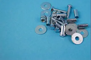 Screw Prints: bolts, nuts, bushings on a blue background with empty space to fill