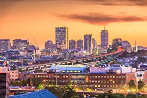 Boston, Massachusetts, USA skyline with bridges and highways at dusk