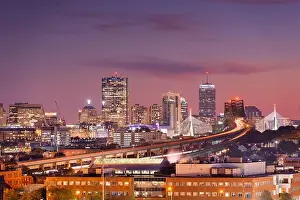 Boston, Massachusetts, USA skyline with bridges and highways at dusk