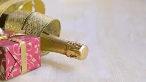 Twinkling Prints: The bottle of champagne with gold glossy ribbon and red gift