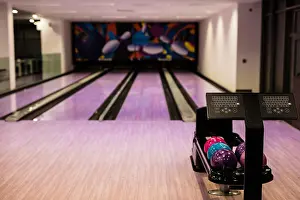 Competitive Prints: Bowling balls and wooden lane in bowling hall
