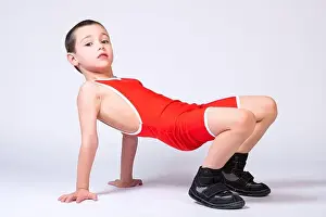 Gymnastic Prints: A boy athlete in sportswear and wrestling outfits does an exercise