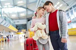 Boy and girl as first love together in the airport terminal before a trip