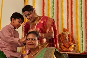 Ganapati Prints: Boy helping his mom to tie his grandmother's hair during Ganesh Chaturthi