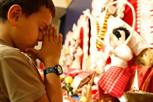 Durga Puja Prints: Boy praying during Durga puja