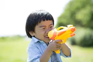 Preschooler Prints: Boy taking aim with water pistol