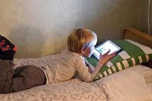 Three Quarter Length Prints: Boy using digital tablet