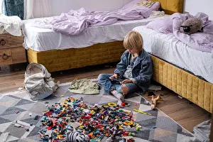 Messing Prints: boy using phone, playing phone games in messy childrens room