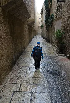 Holy Land Prints: Boy walking under the rain in the streets of the Jewish Quarter