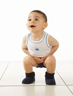 Vest Prints: Boy wearing vest, pants and slippers, crouching, 15 months