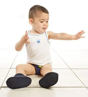 Vest Prints: Boy wearing vest, pants and slippers, sitting on the floor, 15 months