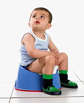 Potty Prints: Boy wearing vest and slippers, sitting on potty, 15 months