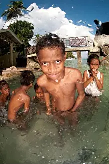 Maluku Prints: Boys playing by jetty in shallow water, Ambon, Indonesia