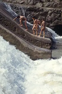 Martial Art Prints: Boys and teenagers having fun in a river in the ancient town Feng Huang in Hunan Province of China