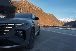 Stationary Prints: Brand new Hyndai Tucson SUV car parked by the side of the road with mountain range