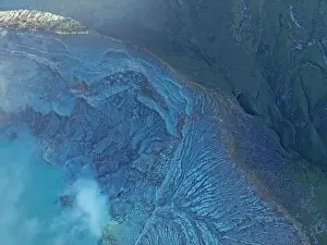 Breathtaking aerial view of majestic Ijen volcano crater mountain range with fog