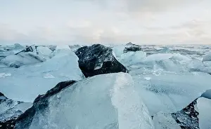 Slow Motion Prints: Breathtaking diamond beach on Iceland in winter with large ice blocks, ice cubes