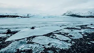 Slow Motion Prints: Breathtaking glacier in Iceland with black rock and large ice sheets