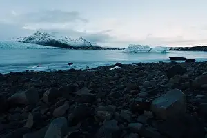 Slow Motion Prints: Breathtaking glacier in Iceland with black rock and large ice sheets