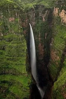 From above of breathtaking scenery of large Jinbar Waterfall with powerful stream flowing down rocky ravine