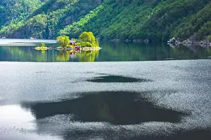 Breathtaking view of small island with red house in Lovrafjorden fjord, Norway. Landscape photography