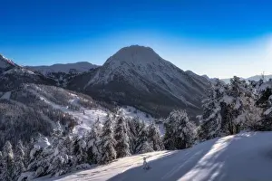 Snowcapped Prints: A breathtaking winter scene beautifully showcases majestic snowcovered mountains and trees