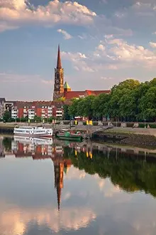 Bremen, Germany. Cityscape image of riverside Bremen, Germany with reflection of the St. Stephani Church in Weser River at summer sunrise