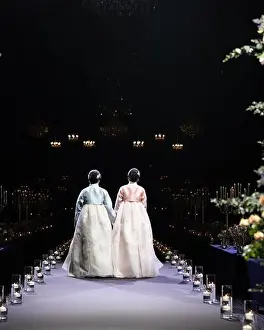 Aisle Prints: Bride and the groom's mother are wearing hanbok and walking at the end of the aisle