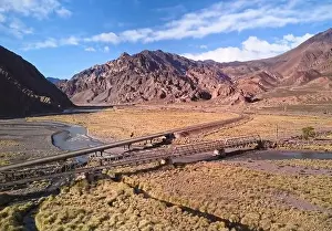 Bridge across Mendoza River by the Andes mountains near Uspallata, Argentina. Aerial view